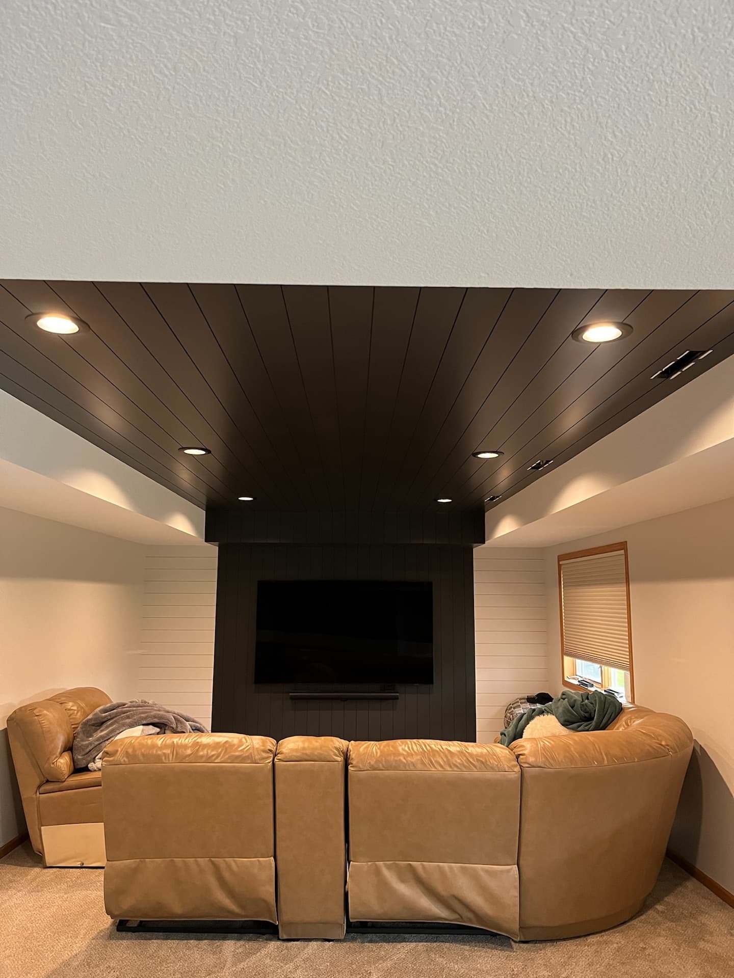 Basement media room with custom ceiling treatment